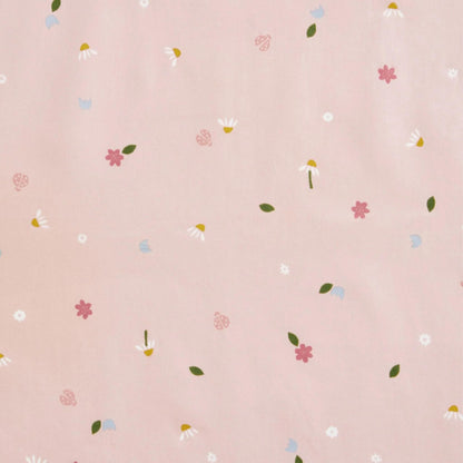 Close-up of the ErgoPouch Sleep Suit Bag fabric in Daisies print, featuring a delicate pattern of flowers, leaves, and ladybirds on a soft pink background.