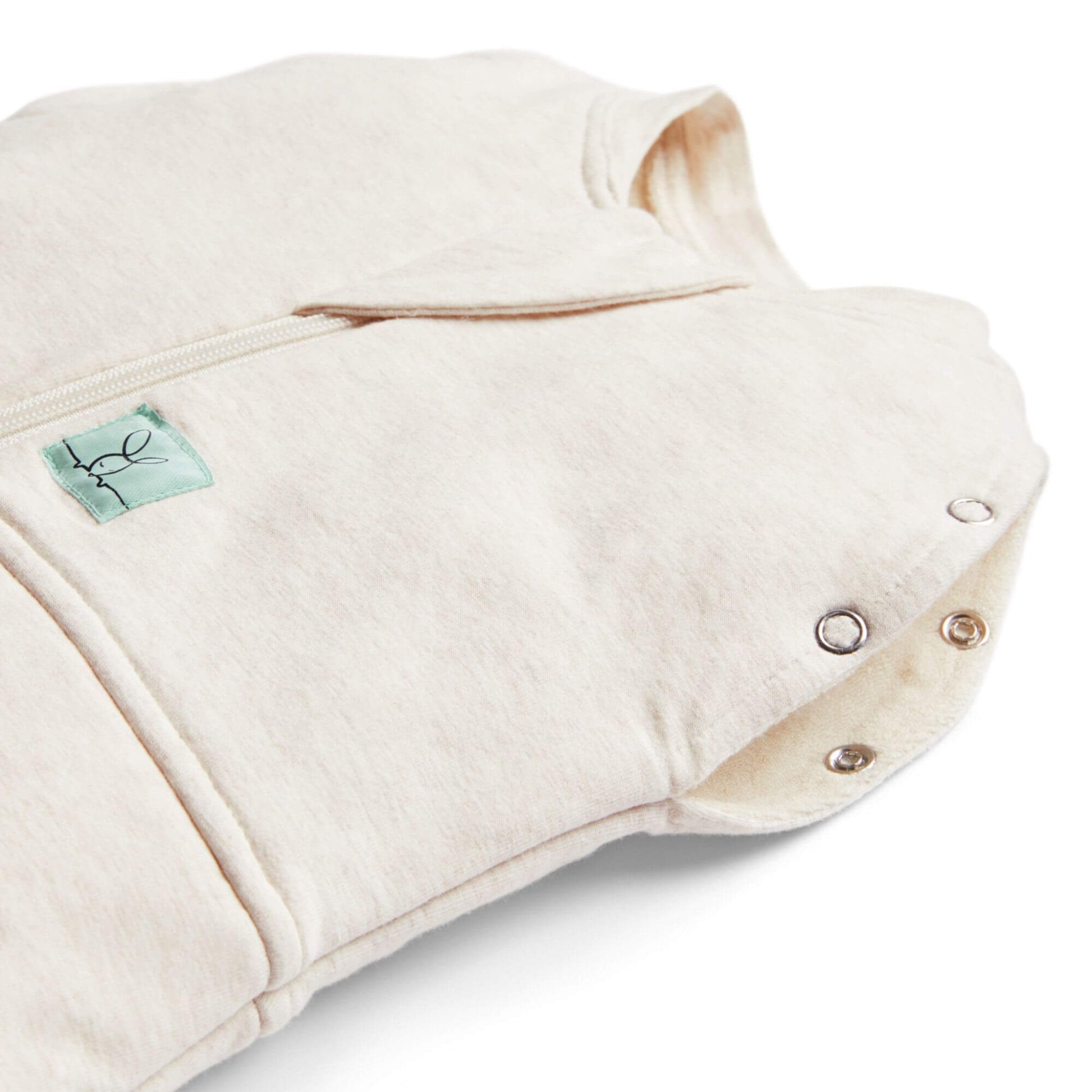 Close-up of  a winter weight 2.5 TOG baby swaddle bag in oatmeal, showing snap buttons and zip detail, made from organic, breathable fabric for winter warmth.