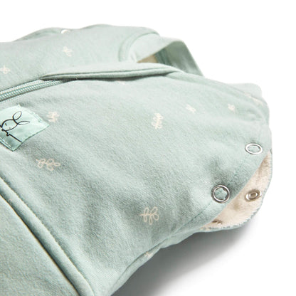 Close-up of a baby swaddle bag in sage, showing snap buttons and zip detail, made from organic, breathable fabric.