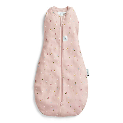 ErgoPouch Cocoon Swaddle Bag in a daisies print, featuring a soft pink fabric with delicate floral accents and a zip-up design.