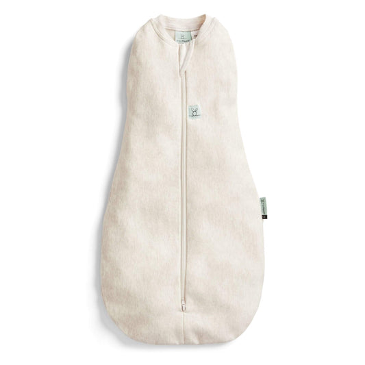 ErgoPouch Cocoon Swaddle Bag in a soft oatmeal hue, featuring a zip-up design for secure swaddling and easy transition to sleeping bag.