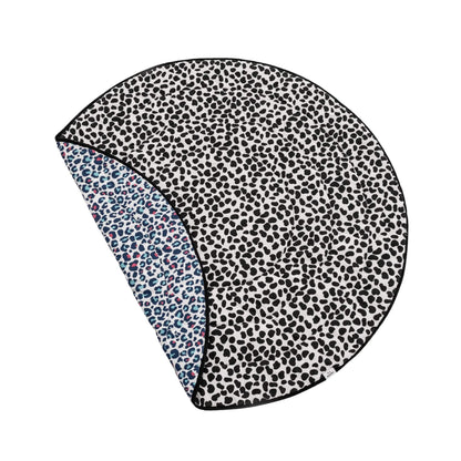 Etta Loves Reversible Sensory Baby Playmat in Animal Print design, round padded mat shown partially folded to reveal black and white high contrast side and colourful leopard print reverse.