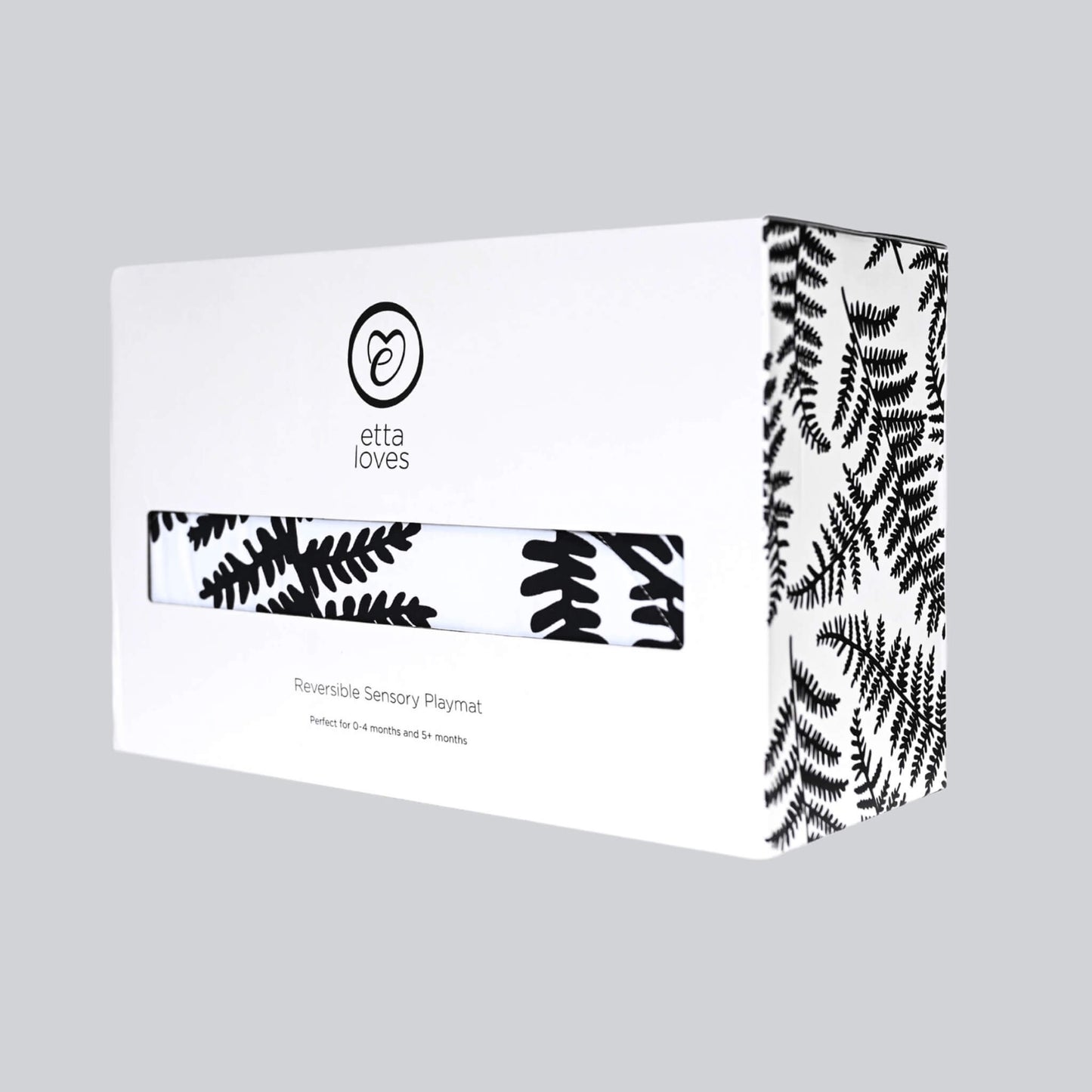 Branded cardboard product box with botanical print design and sensory playmat visible through front window.