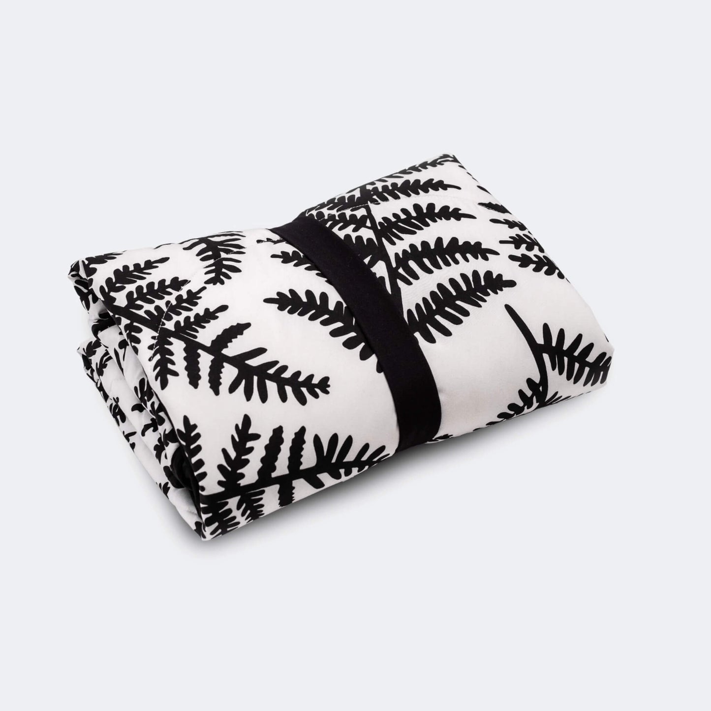 Rolled padded playmat secured with black elastic strap for compact storage or travel.