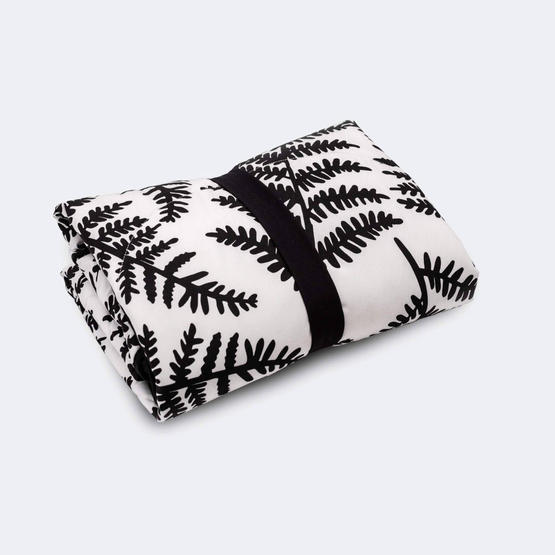 Rolled padded playmat secured with black elastic strap for compact storage or travel.