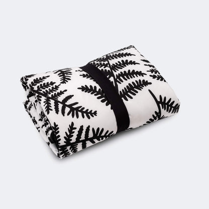 Rolled padded playmat secured with black elastic strap for compact storage or travel.