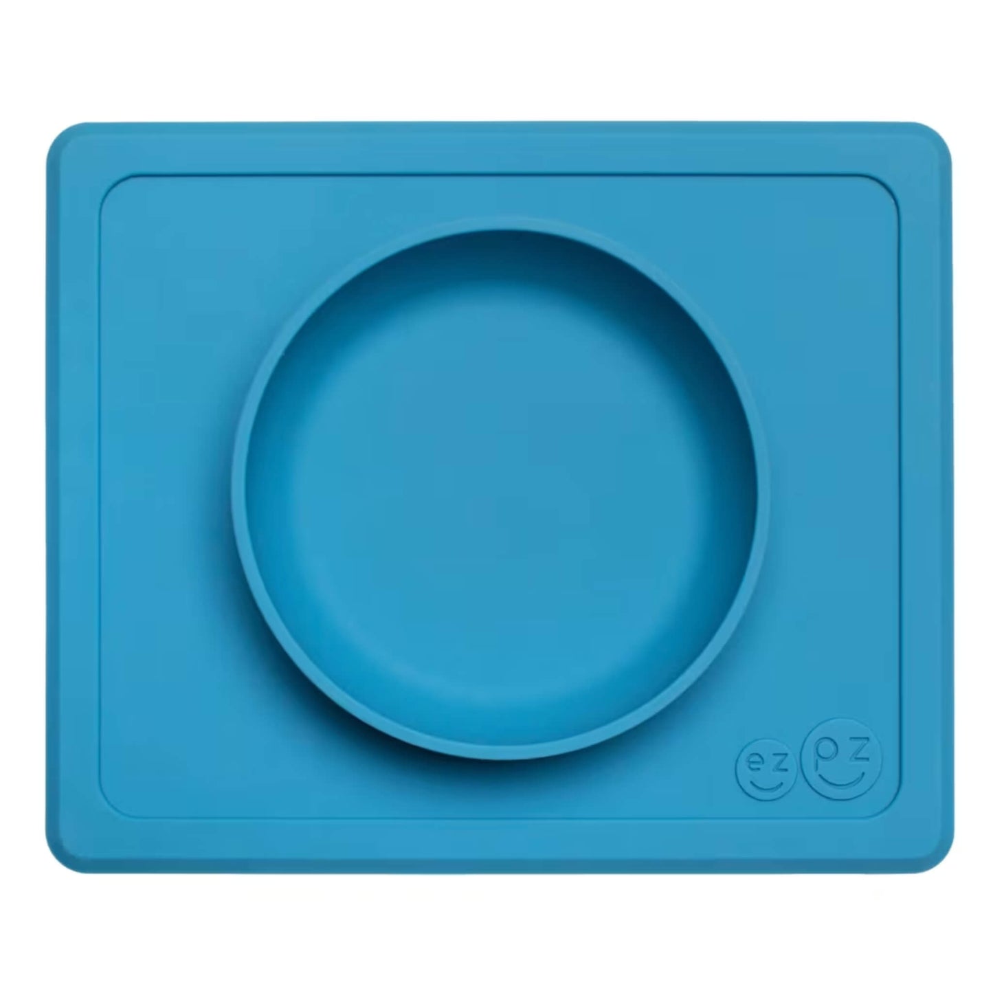 EzPz Mini Bowl in blue shown from above, a silicone suction bowl built into a rectangular placemat to reduce spills during baby mealtimes.