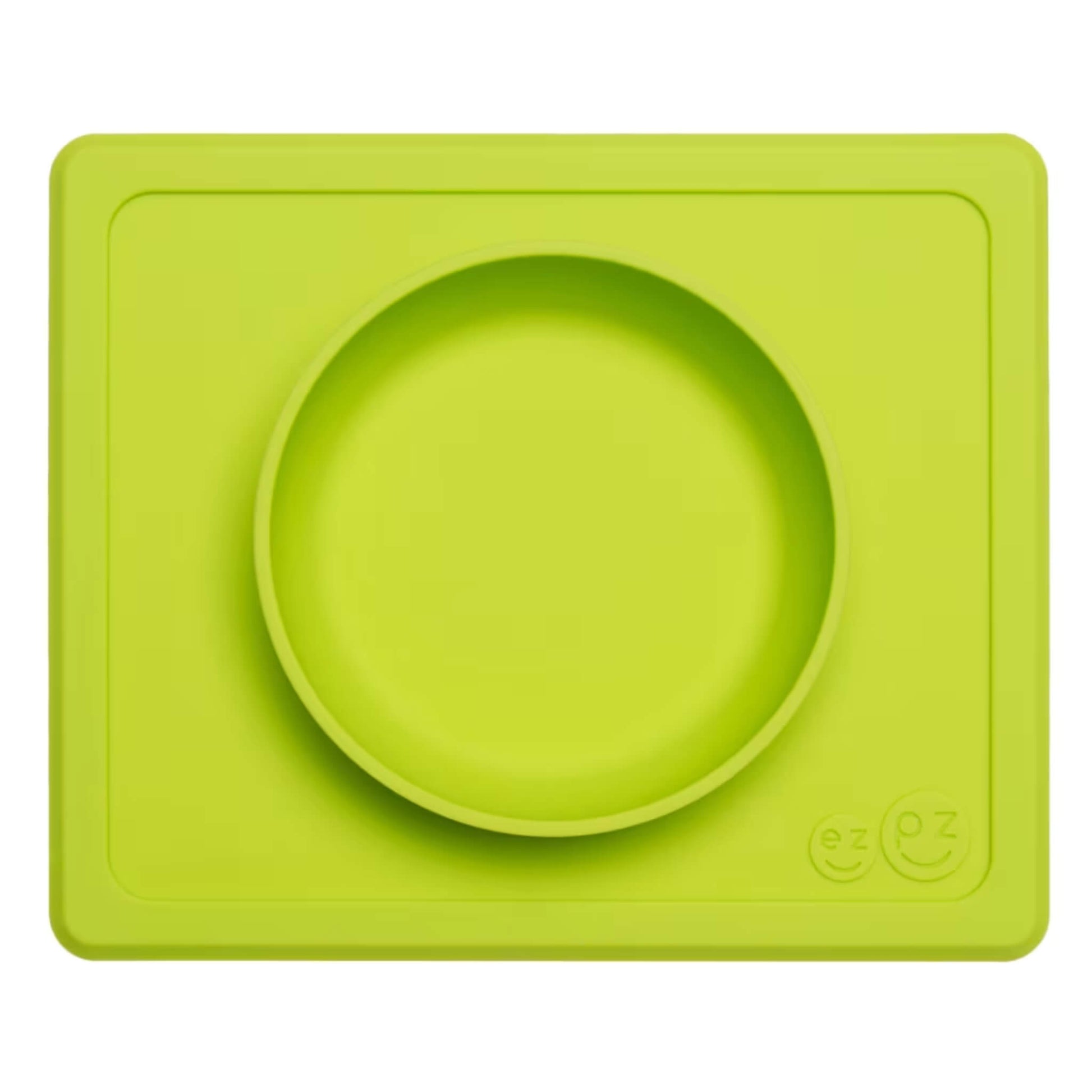 ezpz Mini Bowl in lime shown from above, a silicone suction bowl built into a rectangular placemat to reduce spills during baby mealtimes.