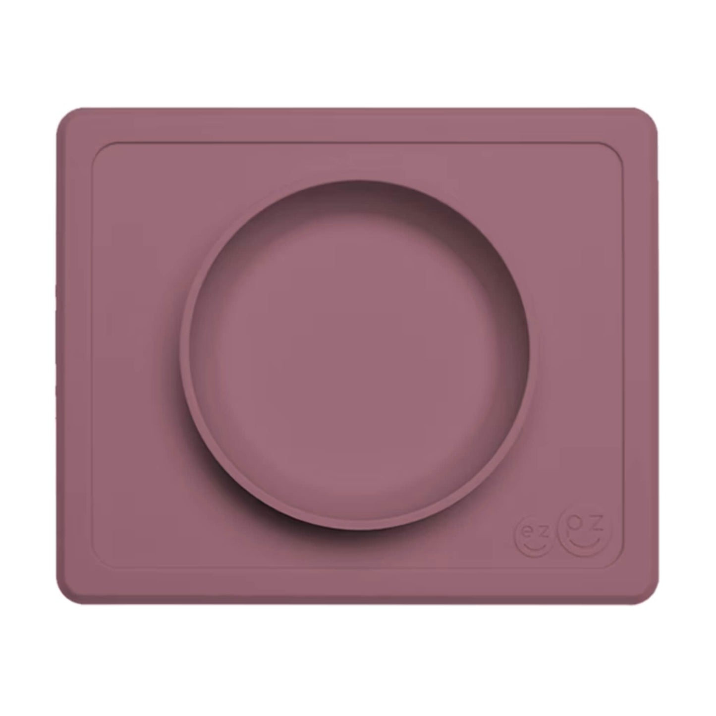 Mauve Mini Feeding Bowl shown from above, a silicone suction bowl built into a rectangular placemat to reduce spills during baby mealtimes.