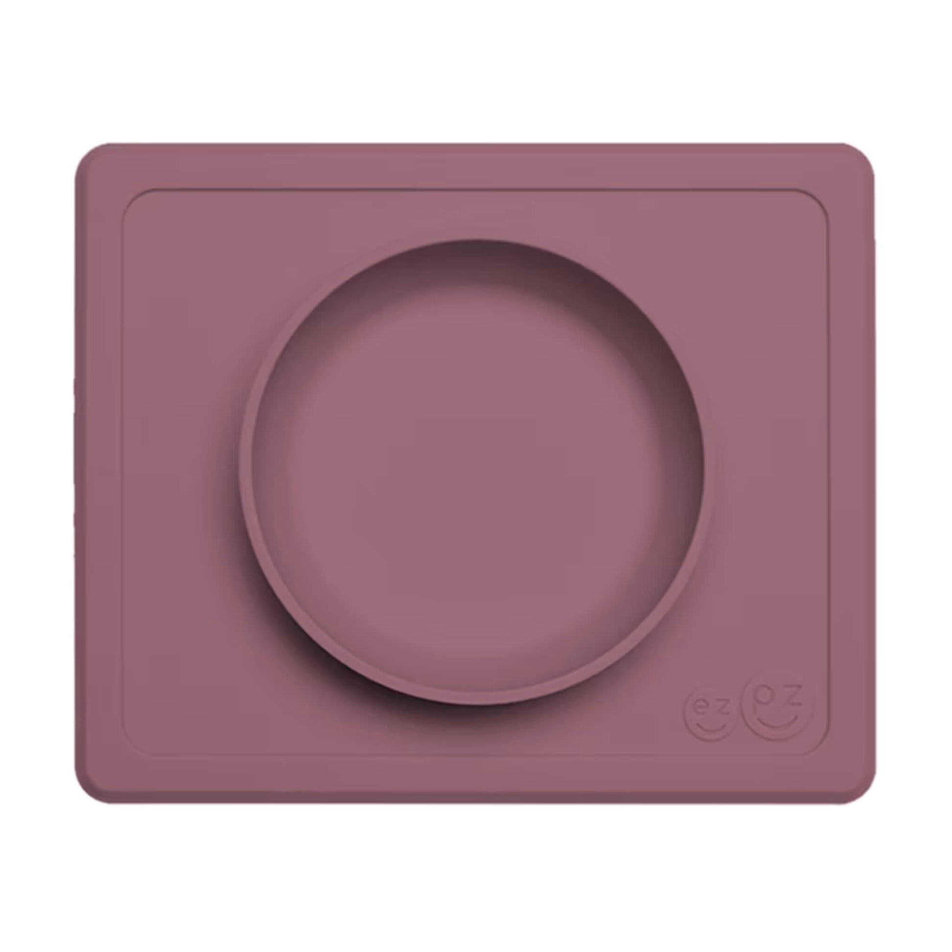 Mauve Mini Feeding Bowl shown from above, a silicone suction bowl built into a rectangular placemat to reduce spills during baby mealtimes.