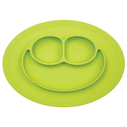 Ezpz Mini Mat in lime coloured silicone, an all-in-one suction placemat and baby plate with three divided sections arranged in a smile design.