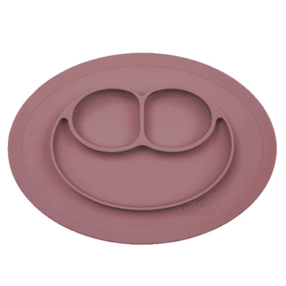Ezpz Mini Mat in mauve silicone, a suction placemat and baby plate in one, featuring three divided sections in a smiley face layout.