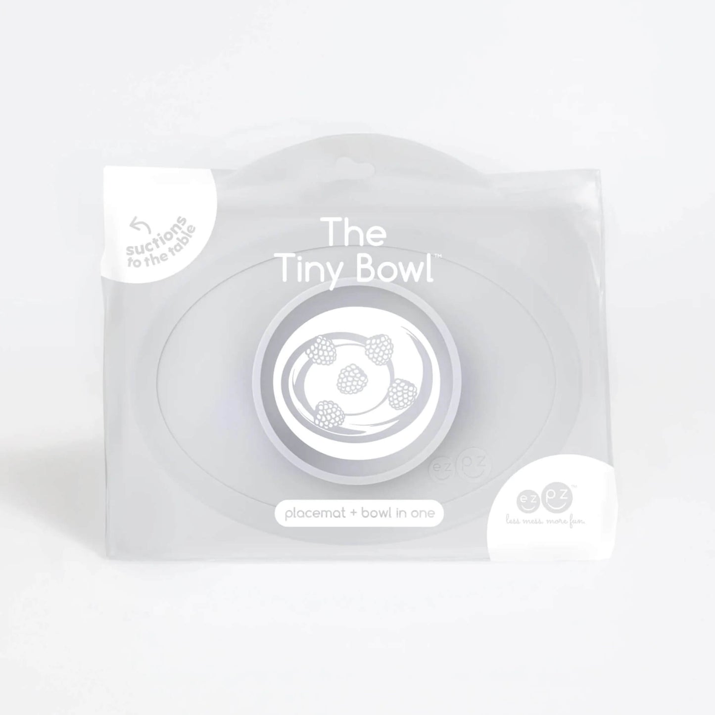 Retail packaging of a Tiny Bowl in pewter with product illustration of raspberries inside the bowl and text reading placemat + bowl in one.