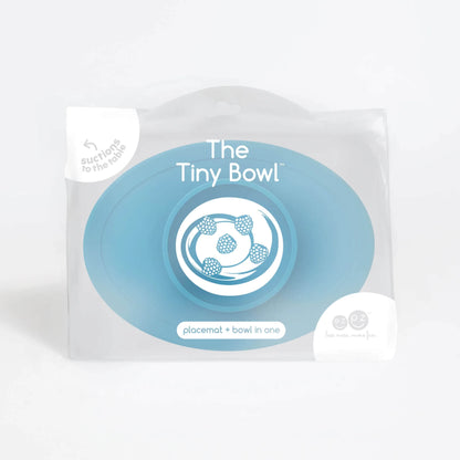 Product packaging showing the ezpz Tiny Bowl with an illustration of raspberries inside the bowl and text that reads placemat + bowl in one.