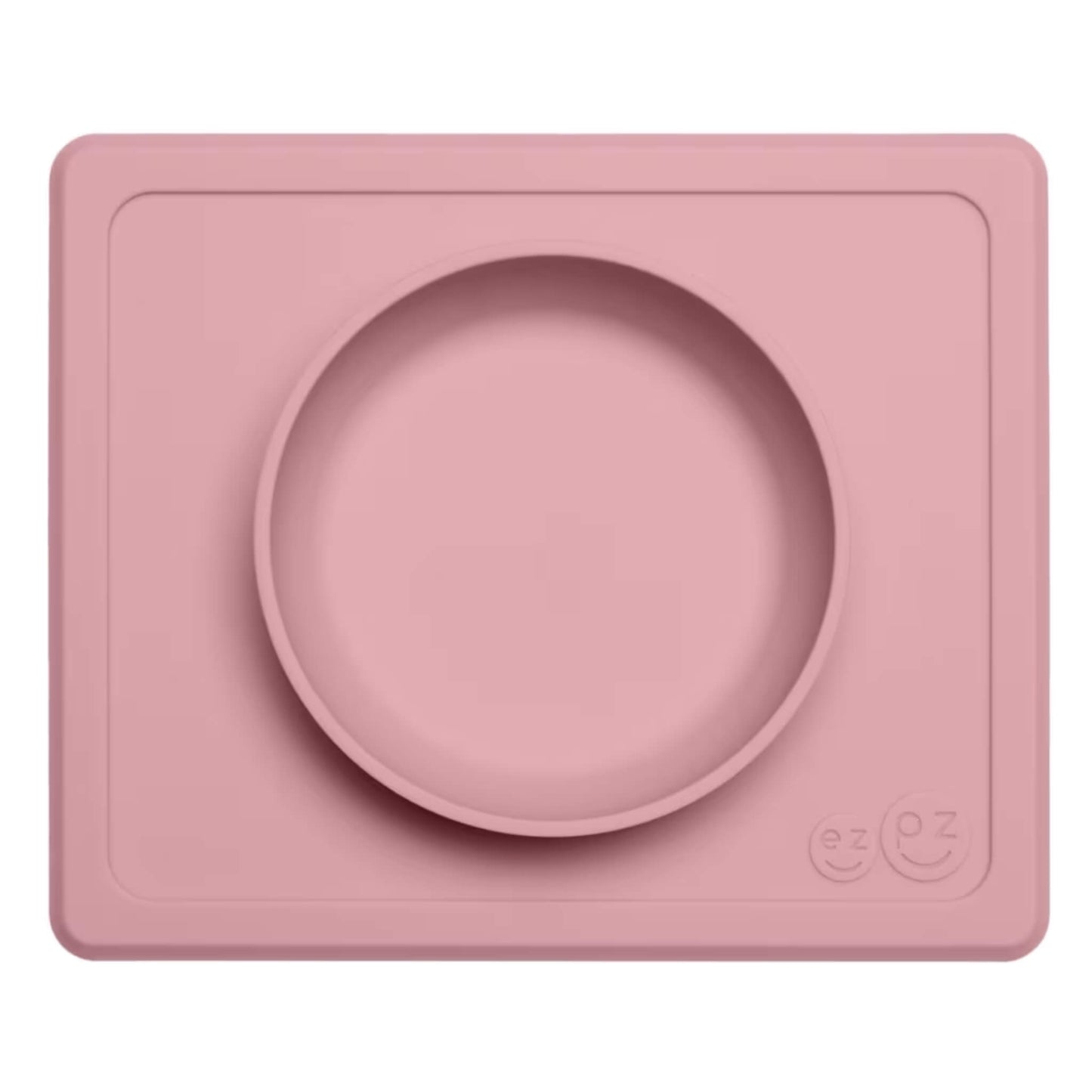 Ezpz Mini Bowl in blush pink, a silicone placemat and bowl in one that suctions to the table to reduce spills during toddler mealtimes.