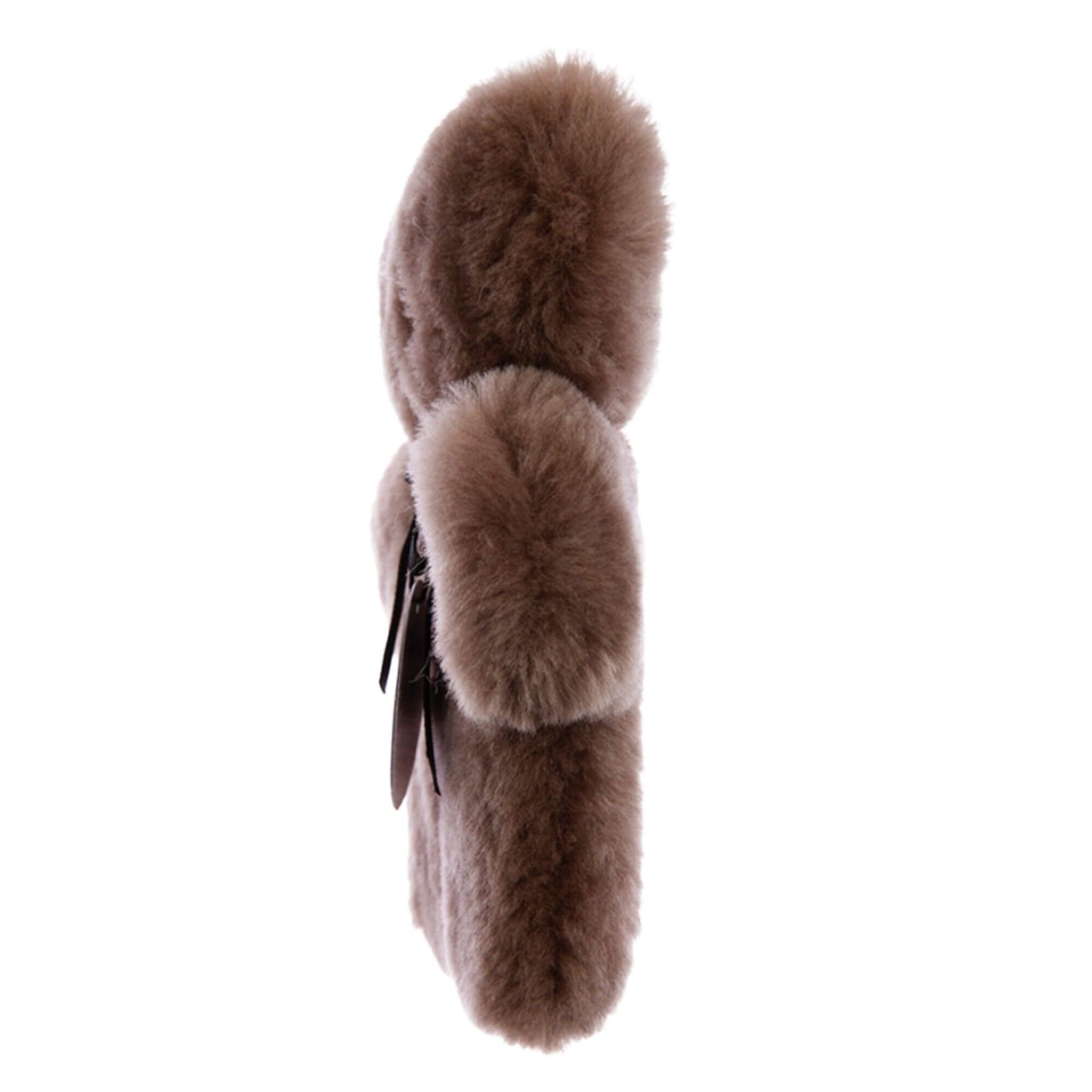 A side view of a flat sheepskin teddy comfort toy in chocolate brown, highlighting a slim, lightweight profile with dense plush fleece and softly rounded ears.