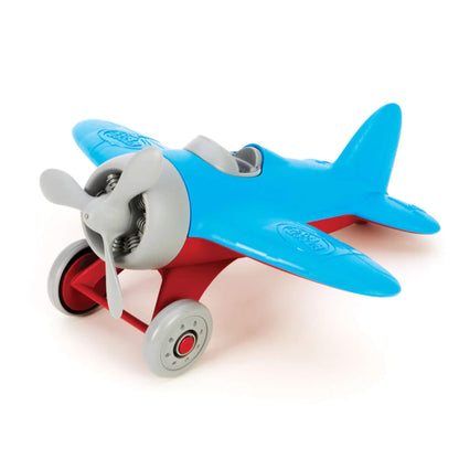 Angled side view of a toy airplane with smooth blue wings, red support struts and visible cockpit seating.