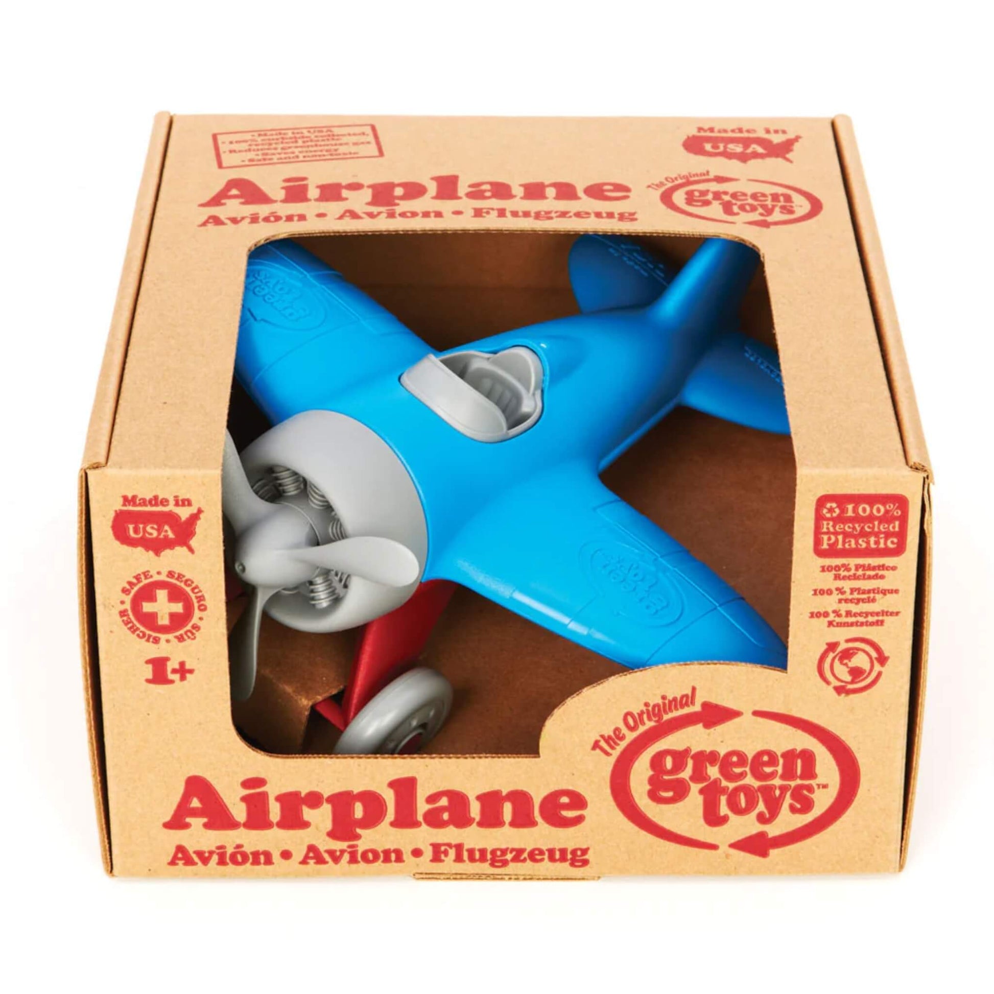 Blue toy airplane displayed inside its cardboard packaging with multilingual product labelling and age guidance printed on the front.