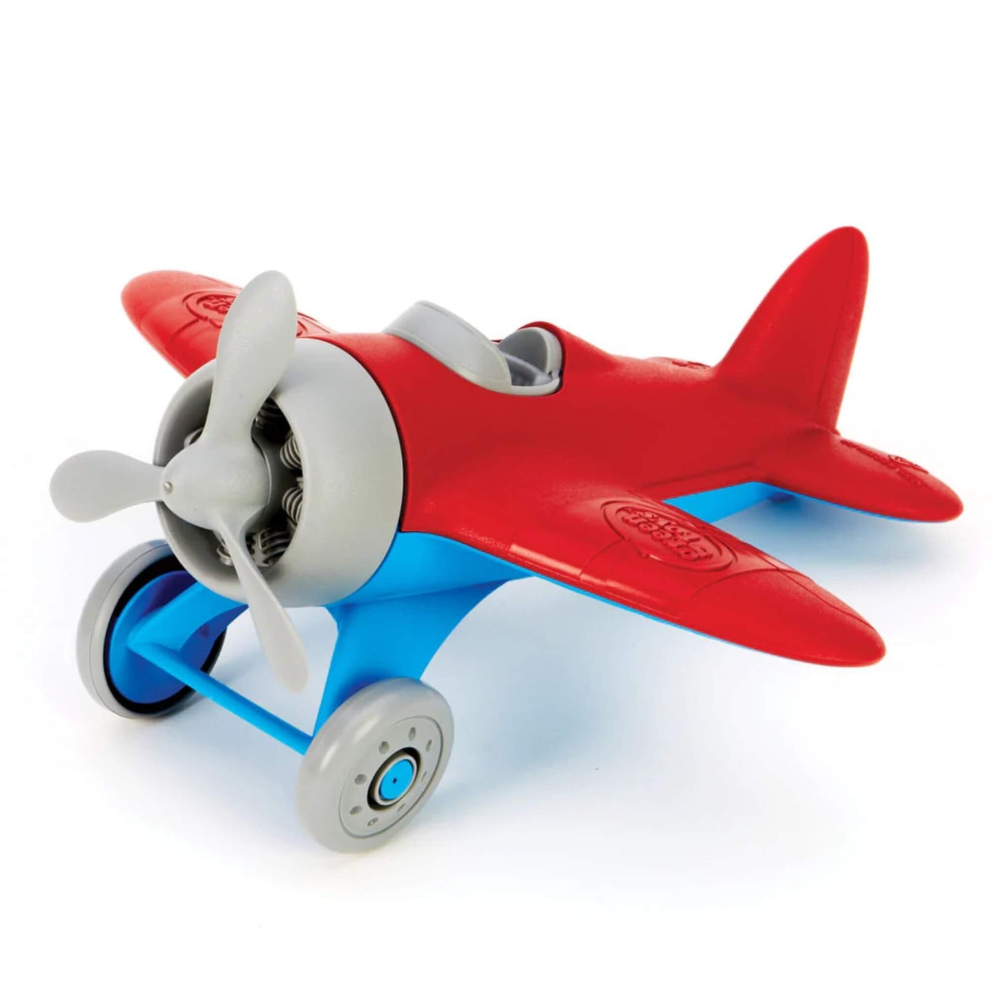 Front-facing view of a red and blue toy airplane with spinning propeller and two-wheeled landing gear, placed on a neutral background.