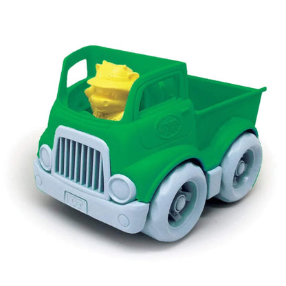 Close-up of the green toys pickup truck with a yellow farmer figure sitting in the driver's seat, viewed from the front.