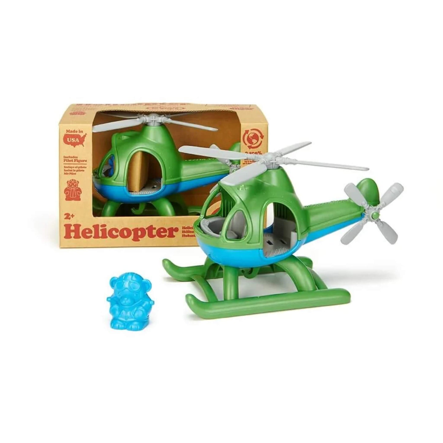 Toy helicopter and pilot figure displayed next to its cardboard packaging, showing product setup and retail presentation.