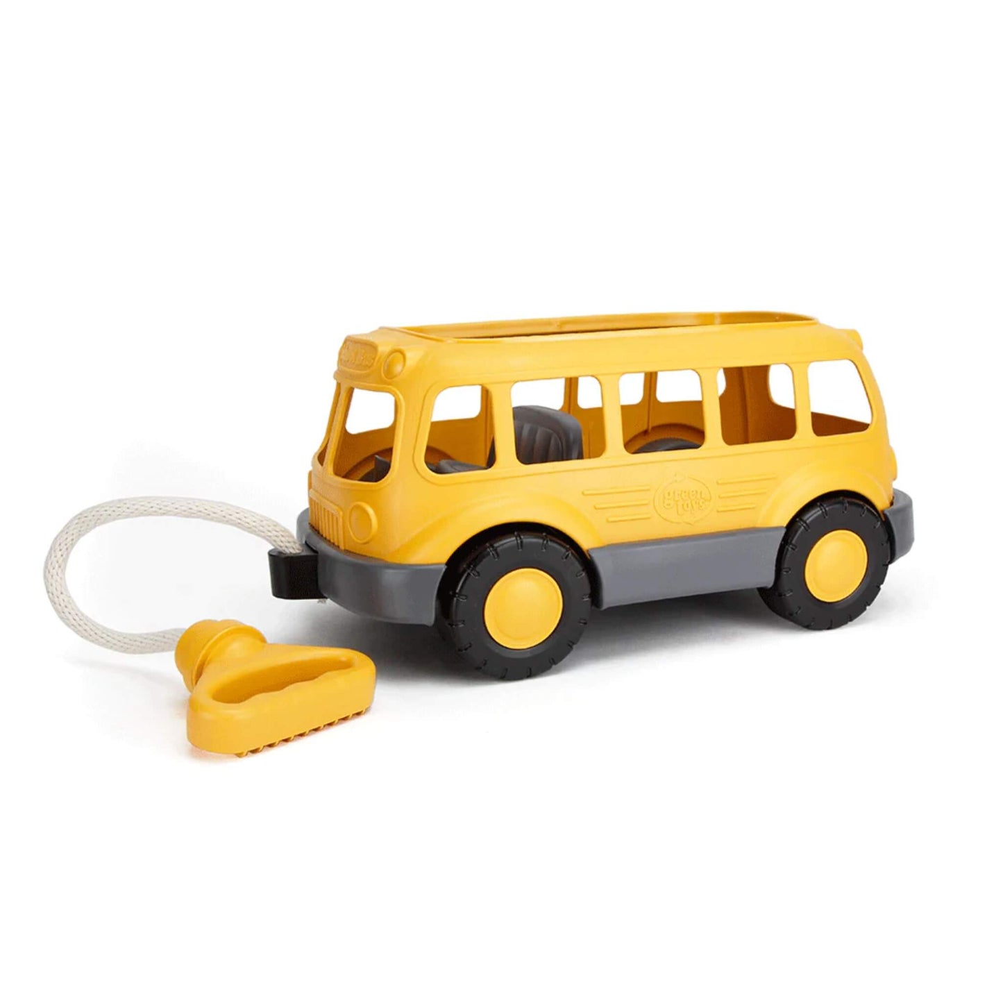 Green Toys Pull Along School Bus Wagon with chunky black wheels and cotton rope handle, shown on a plain white background.