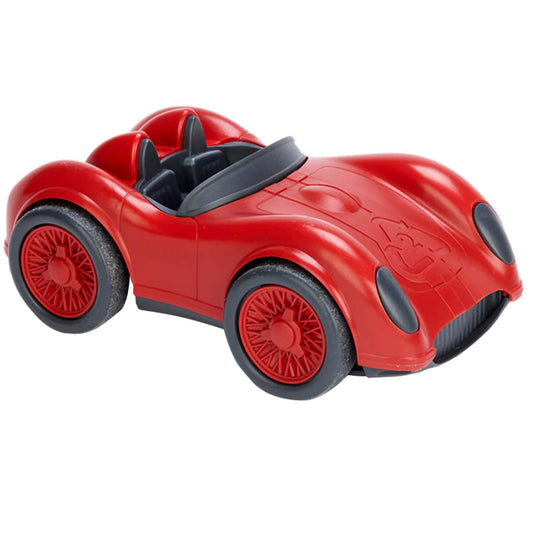 Angled view of the red racing car showing sculpted curves, twin seats and a black steering wheel.