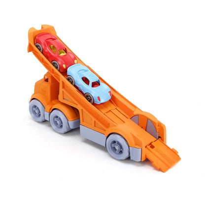 Rear view of the orange racing truck showing the ramp detail and textured tyres, with red and blue cars in place for racing.
