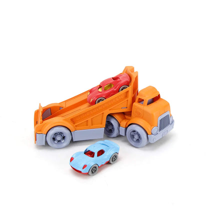Truck shown mid-unloading with the red car still on the ramp and the blue car already driven off, highlighting play interaction.