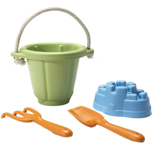 Green Toys Sand Play Set with green bucket and rope handle, orange spade and rake, and a blue sandcastle mould arranged on a white background.