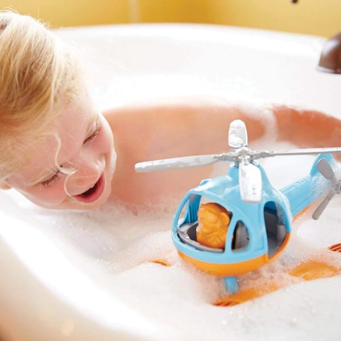 Close-up of the Seacopter floating in the bath, partially covered in bubbles, with the bear pilot visible inside.
