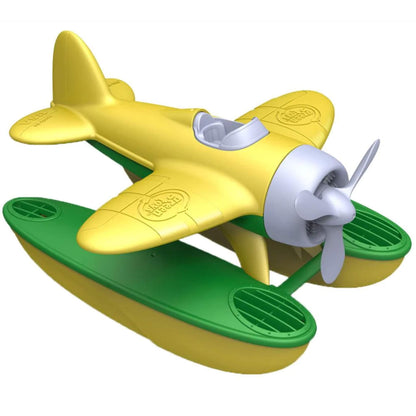 Green Toys Seaplane with yellow wings and green pontoons shown angled to the side, featuring a spinning grey propeller and embossed branding on the wings.