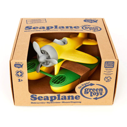 Green Toys Seaplane with yellow wings inside branded packaging, clearly displaying the product name, age suitability and sustainability details.