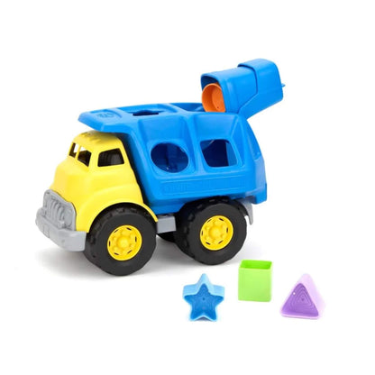 Truck with rear flap open and orange shape block visible inside. Other shapes placed neatly in front of the truck.