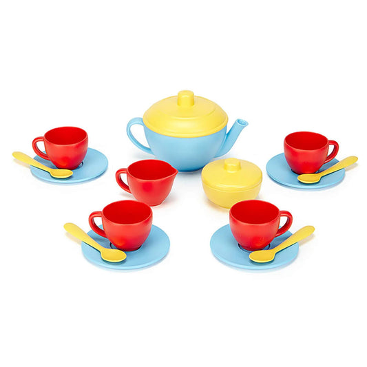 Green Toys Tea Set with a blue teapot and yellow lid, four red cups on blue saucers, four yellow spoons, a matching sugar bowl and milk jug.