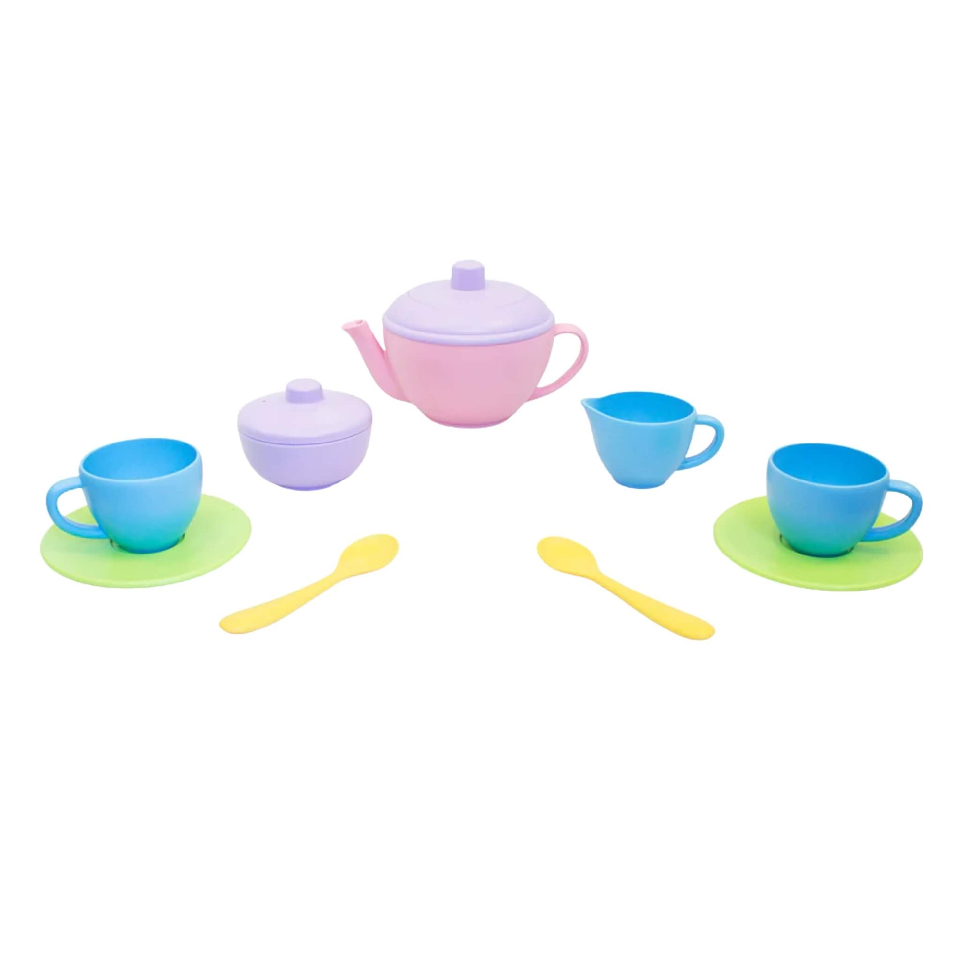Green Toys Tea for Two set with pink teapot, purple sugar pot, blue cups, green saucers and yellow spoons, arranged on a white background.