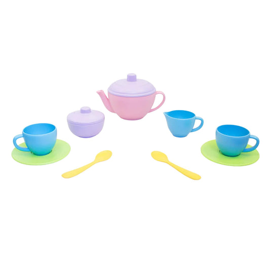 Green Toys Tea for Two set with pink teapot, purple sugar pot, blue cups, green saucers and yellow spoons, arranged on a white background.
