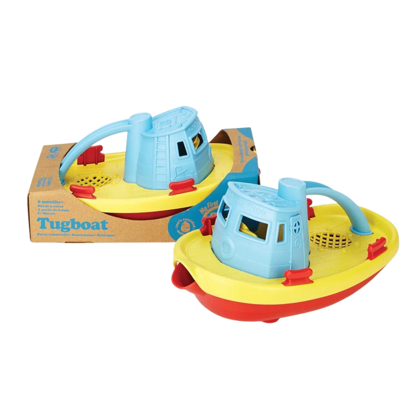 Two Green Toys Tugboats placed beside each other, one loose and one inside eco-friendly cardboard packaging.