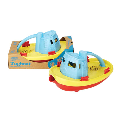 Two Green Toys Tugboats placed beside each other, one loose and one inside eco-friendly cardboard packaging.