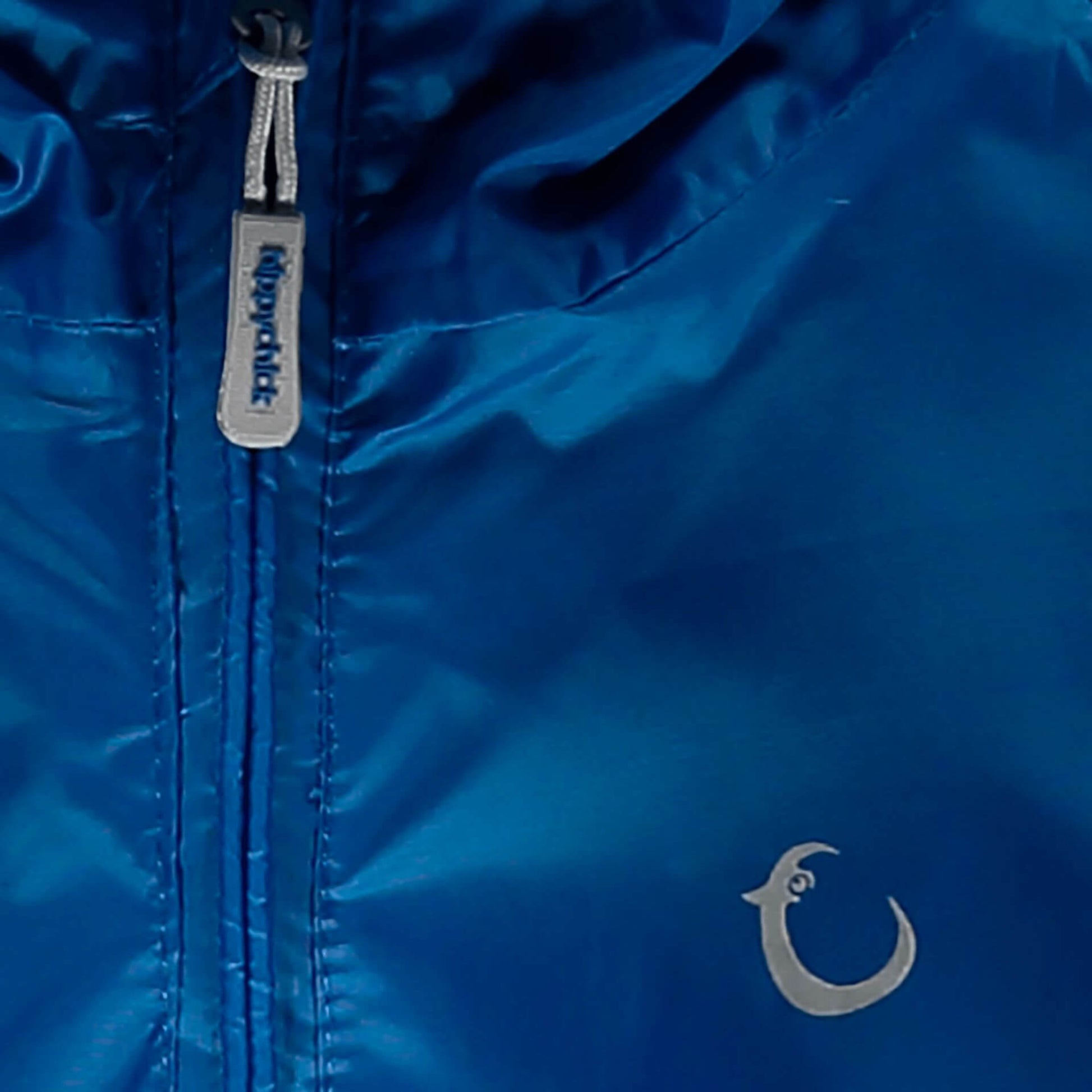 Close-up view of a blue waterproof suit zip and reflective brand logo detail.