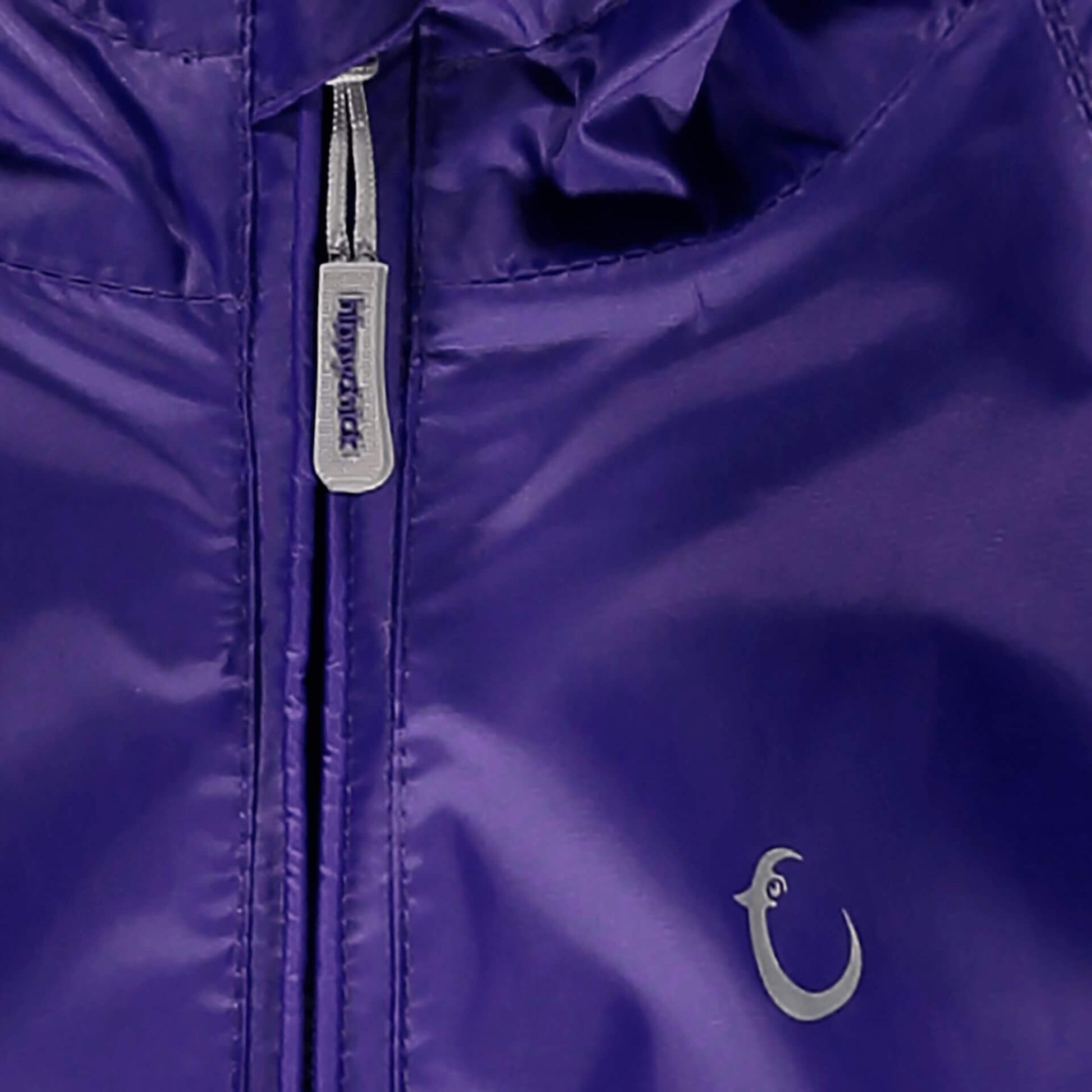 Close-up of a deep purple Packasuit zipper with a small brand logo near the bottom right corner.