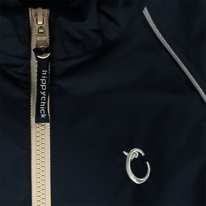 Close-up of navy waterproof fabric with beige zip, showing reflective piping and embroidered Hippychick brand logo.