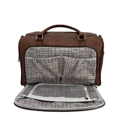 Open front compartment of a nappy changing bag showing internal pockets, mesh divider, and Isoki logo lining.