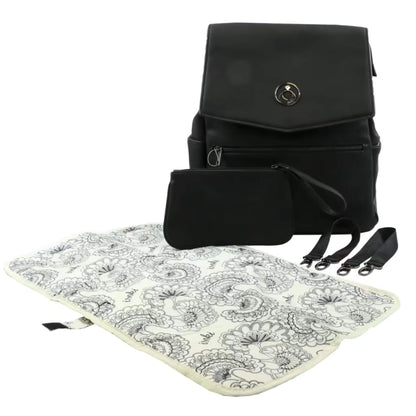 Open patterned change mat laid beside black backpack, small accessories pouch, and stroller clips on a plain surface.