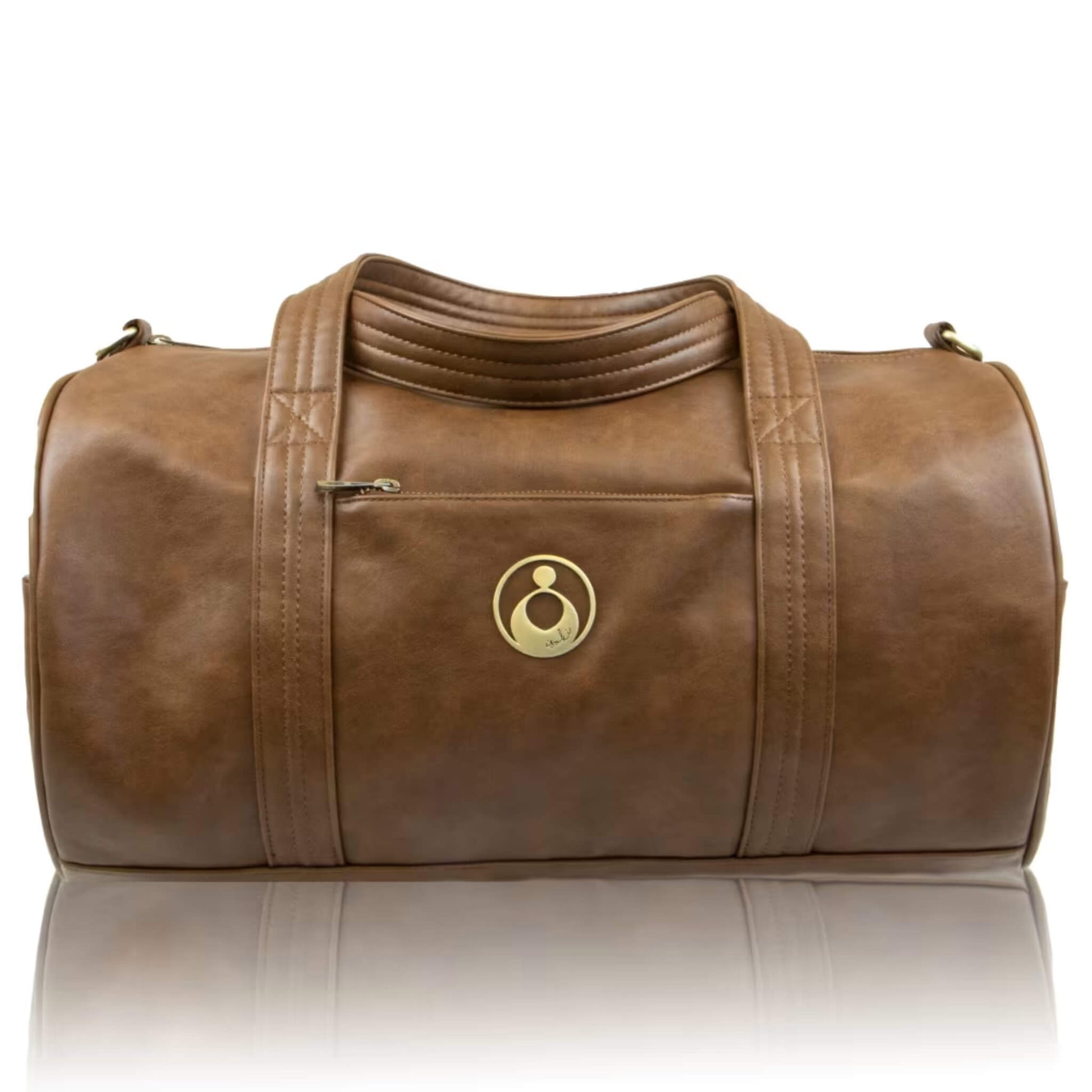 Isoki Kingston Duffle Bag in Redwood showing soft faux-leather finish, gold logo emblem, and front zip pocket.