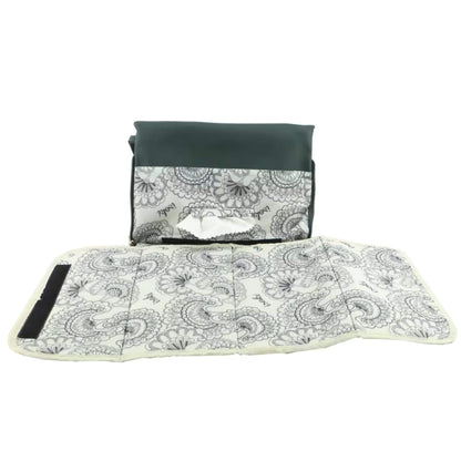 Full-length view of the green changing mat fully unfolded, revealing the patterned wipe-clean surface and padded design.