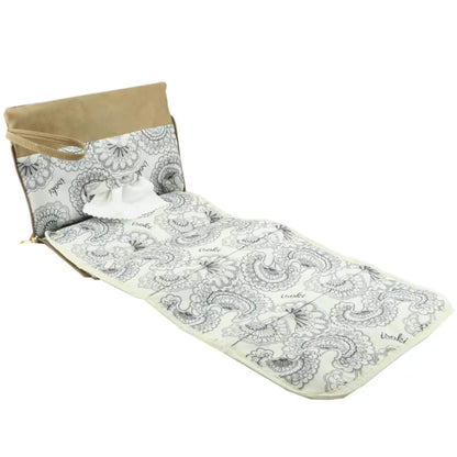 Angled view of the open Windsor change mat clutch in Latte beige, showing the extended changing mat and detailed printed interior.