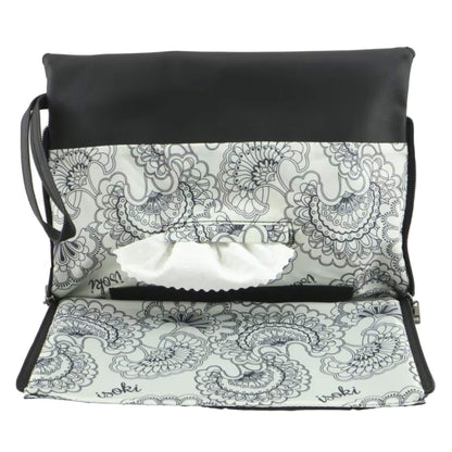 Black baby change mat clutch opened flat, showing the built-in patterned change mat and central wipes access slot.