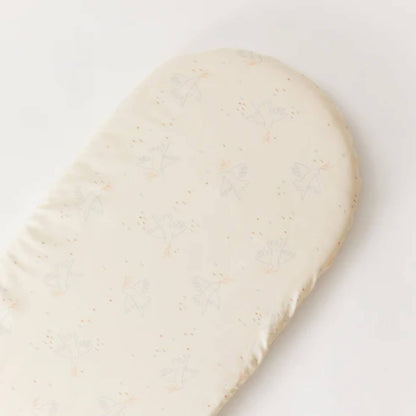 A fitted sheet laid flat to show a rounded mattress shape and an evenly spaced bird pattern across the surface.