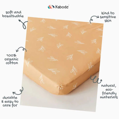 A product feature graphic showing a fitted sheet labelled as soft and breathable, kind to sensitive skin, made from organic cotton, and easy to care for.